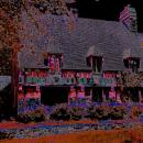 Photograph of an oversaturated cottage that makes the picture look dark.