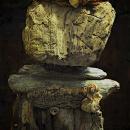 Life-sized wood sculpture, designed to resemble a person in the abstract. 