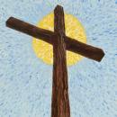 Wooden cross in front of sun beam