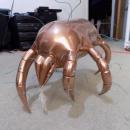Brass crab statue with wires poking out which reveals Roger's beginning stages of this piece. 