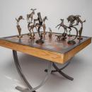 Forged in fire, my chess set is my interpretation of chess pieces as wild animals of North America. My design is inspired by my life spent outdoors, working and playing in the American mountains and deserts. I brought those days under the sun and stars into the feeling of my series of thirty-two sculptures which together create the chess set. My time camping and working in National and State Parks inspired the name, ‘Yellowstone”. My set is oversized and all-together, heavy.