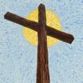 Wooden cross in front of sun beam