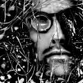 A black & White self-portrait scanograph. My face is looking directly at the viewer. I am wearing thick black framed magnifying glasses. There is debris and detritus floating over my face and throughout the frame. These obstructions represent the floaters I experience in my own vision. This image is from my “Blind Vision” series. 