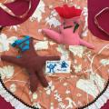 Image of two stuffed sewn monsters on an apron. 