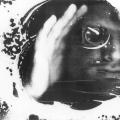 This is one of my most iconic images from my “Blind Vision” series. It is a Black & white scanographic self-portrait. The frame is filled with white foam. My face appears through a darkness at the right side of the frame. There is a monocular in my eye and streaks of white foam across my face. 