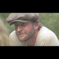 Image of a man with a hat in a film 