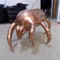 Brass crab statue with wires poking out which reveals Roger's beginning stages of this piece. 