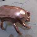 Brass crab statue with wires poking out which reveals Roger's beginning stages of this piece. 