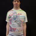 The artist, Pablo Rahner, a latino man, wearing his art t-shirt with a Rocky Horror design on it